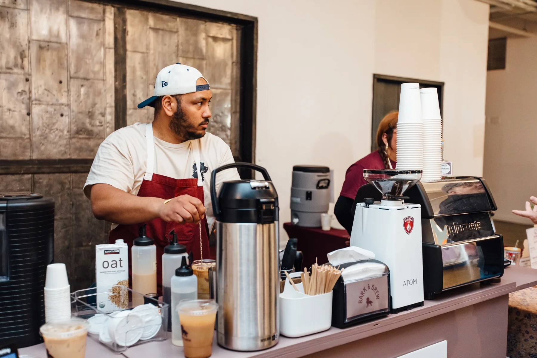 Bark & Brew barista serving coffee at Market for Makers in Brooklyn