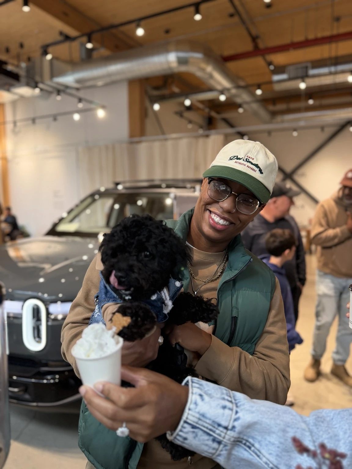 Guest with a dog enjoying a Bark & Brew Barkaccino at Rivian Williamsburg